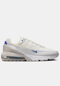 White athletic shoe with mesh upper, blue accents, and a visible air cushioning unit. Features a rounded toe and textured sole.