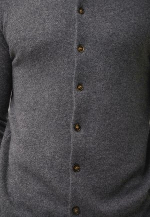 Grauer Wollcardigan mit taillierter Form, der sechs braune Knöpfe entlang der Vorderseite aufweist und eine weiche, strukturierte Oberfläche hat.