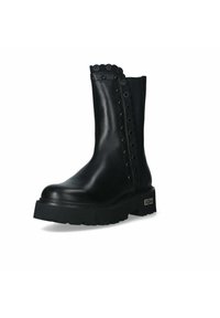 Stivale in pelle nero a metà polpaccio con suola spessa, bordi decorativi a motivo scalloped e occhielli lungo il lato, e etichetta del brand sul tallone.