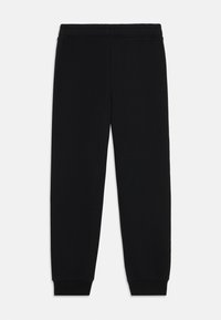 Zwarte katoenen sweatpants met een elastische tailleband en taps toelopende manchetten, met een soepele textuur en een eenvoudig, minimalistisch design.