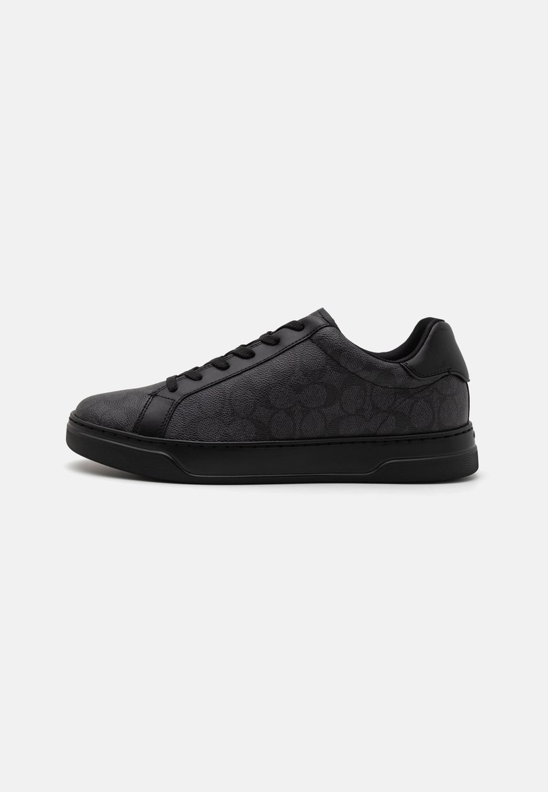 Black sneaker featuring textured leather material, tonal logo pattern, round toe, lace-up front, and rubber sole with subtle tread design.