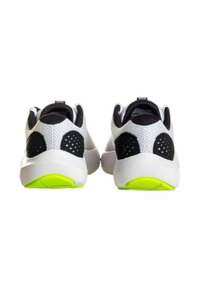 Zapatillas deportivas de malla blanca con acentos en negro, con una forma redondeada y una suela texturizada, complementadas con un detalle en suela de color verde brillante.