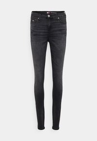 Jean skinny noir taille mi-haute avec délavage, design à cinq poches et fermeture par bouton, étiqueté « Nora Mid Skinny » à la ceinture.