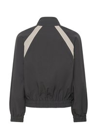 Veste noire avec poignets et ourlet élastiques, ornée de bandes diagonales beiges sur le haut du dos et un col montant.