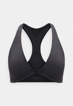 Black racerback sports bra with front clasp and smooth, seamless cups on a plain light gray background.