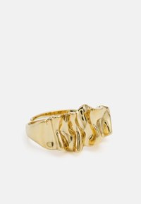 Gold ring with a textured, wave-like design. Smooth finish, polished surface, and a rounded band for comfortable wear.