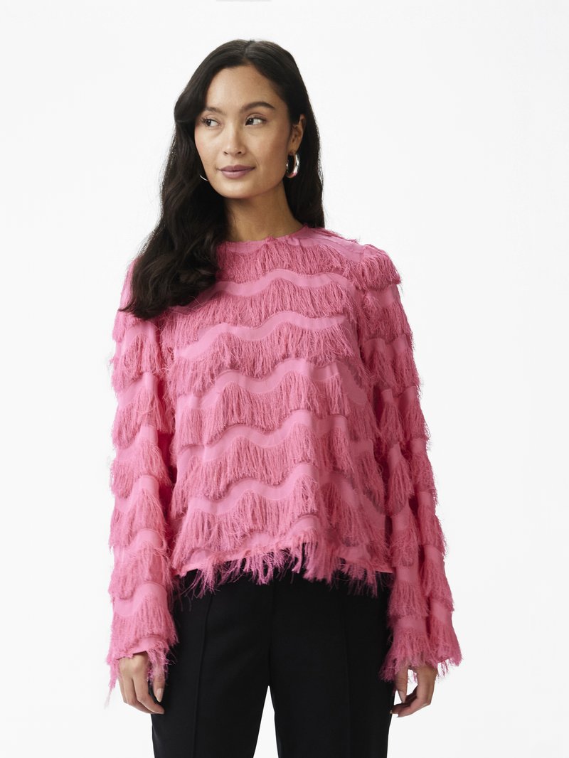 Pink sweater with wavy fringe texture and long sleeves, featuring layered horizontal stripes, loose fit, and raw hem details.