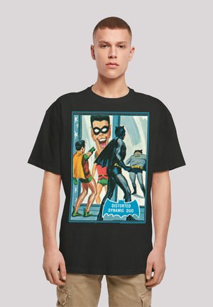 Black t-shirt featuring a vibrant comic-style graphic of two superheroes, with the text "Distorted Dynamic Duo" at the bottom.