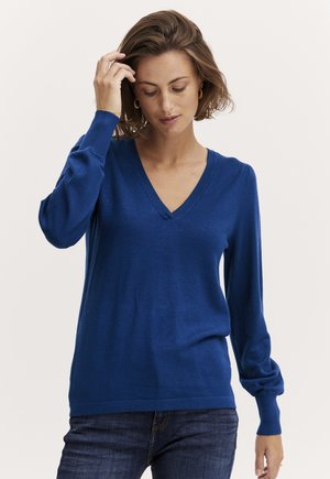 Blå, langærmet sweater med V-hals, lavet af et blødt strikket stof. Har tætsiddende manchetter og en afslappet silhuet.