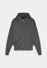 Felpa con zip di colore grigio scuro, realizzata in tessuto morbido, con una tasca a marsupio sulla parte frontale e un logo di un toro ricamato sul petto.