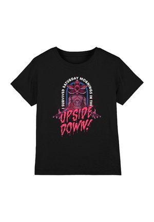 Black cotton t-shirt featuring a graphic design with a central figure wearing glasses, and the text: "I Survived Saturday Mornings in the Upside Down!" in dripping pink.