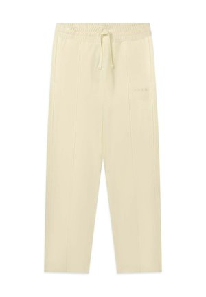 Pantaloni jogger di colore crema con vita elastica, coulisse regolabile e cuciture laterali. Presentano un branding discreto sulla coscia sinistra.