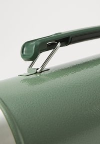 Green metal canister with a smooth, glossy finish, featuring a plastic handle and a metal clip for secure closure.