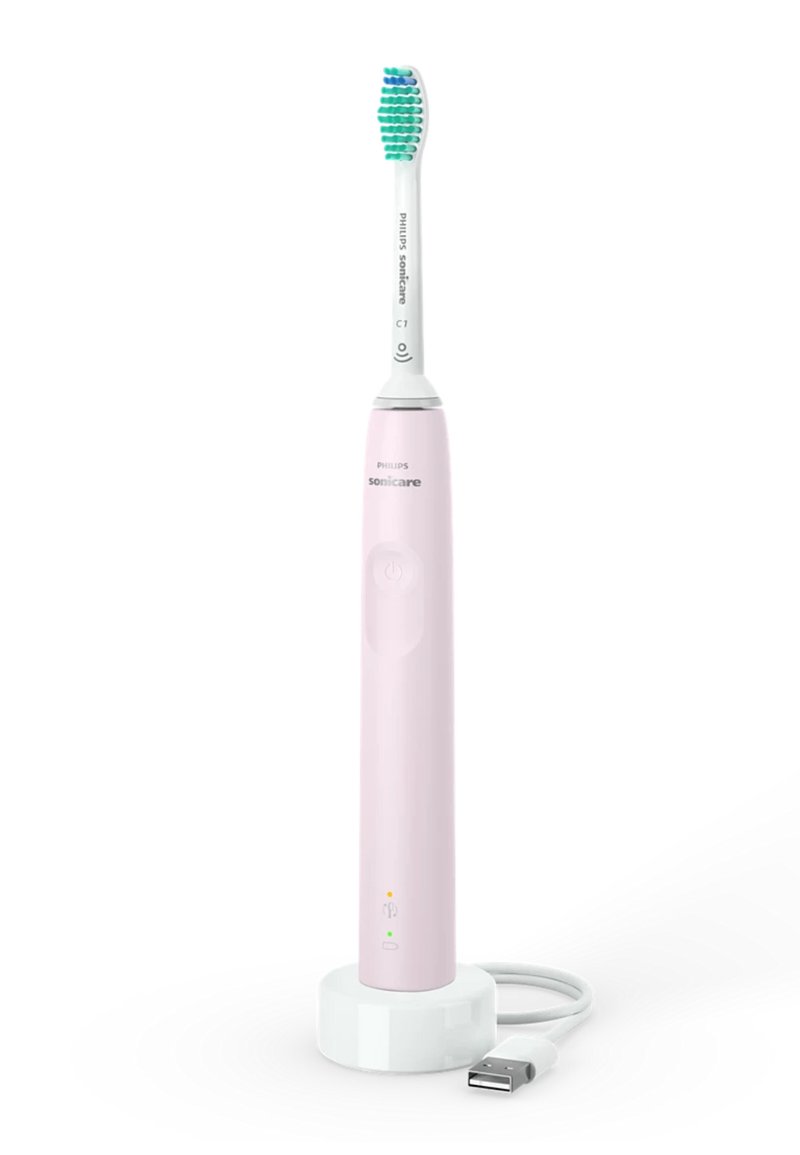 Spazzolino elettrico Philips Sonicare di colore rosa con testina bianca. Presenta un pulsante di accensione, luci indicatrici e una base di ricarica con cavo USB.