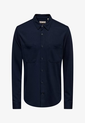 Marineblauw overhemd met knopen, gemaakt van gestructureerde stof, voorzien van een spreadkraag, twee borstzakken en een afgeronde zoom.