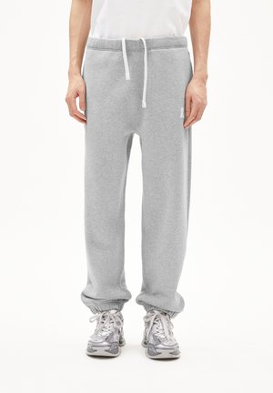 Pantalons de survêtement en coton gris avec une taille élastique et un cordon de serrage ajustable. Chevilles resserrées et petit logo sur le côté droit.