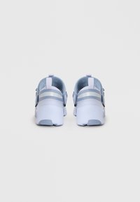Light blue athletic shoes with a smooth texture, featuring adjustable straps and a rounded heel. Rubber sole with slight grip pattern.