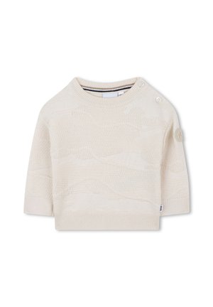 Pull en ivoire court en tricot, à manches courtes, avec un motif texturé, un col rond et deux boutons sur l'épaule gauche.