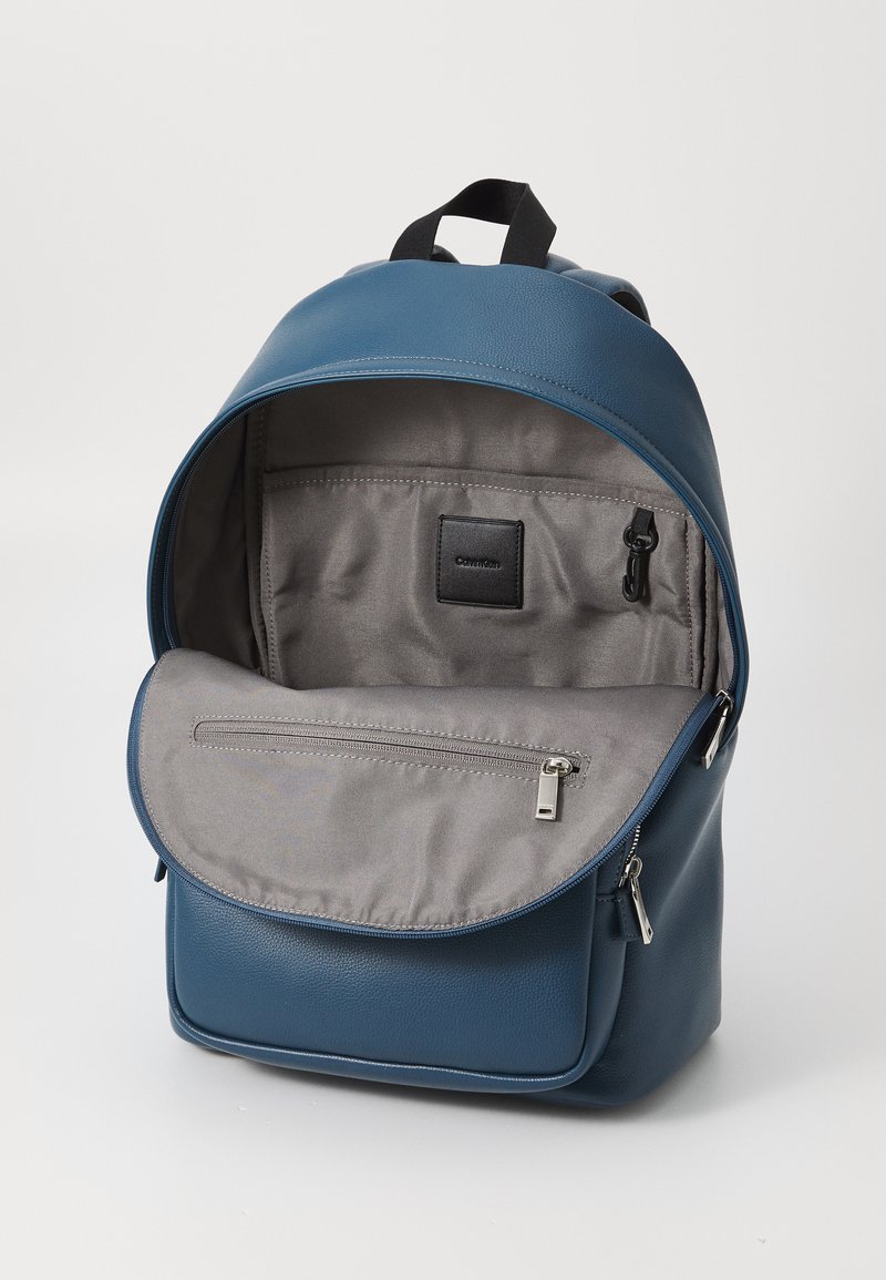 calvin klein blue leather backpack Shop Mens Logan Smooth Travel Te Luggage Factory Structured Dimensions And Thoughtful Details Calvin Klein Backpack in Blue