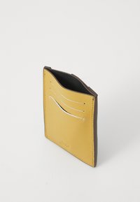 Yellow leather card holder with a dark brown edge, featuring four card slots and a smooth texture, designed for compact storage.