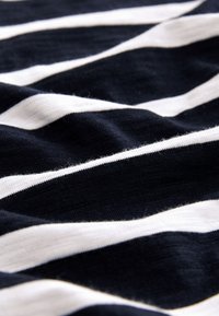 Navy and white striped fabric with a soft, textured finish. Stripes vary in width, creating a wavy, layered appearance.
