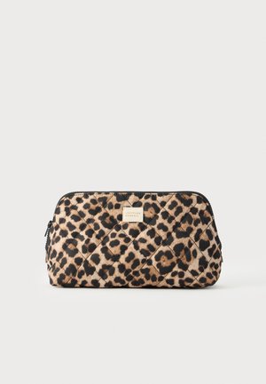 Pochette matelassée à imprimé léopard avec une petite étiquette rectangulaire au centre devant, sur un fond clair uni.