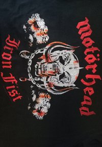 Černé tričko s stříbrno-červeným motivem lebky s rohy, řetězy a nápisem "Motörhead Iron Fist" tučnými červenými písmeny.
