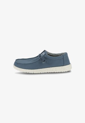 Blauer Canvas-Slipper mit gesprenkelter weißer Sohle, abgerundeter Zehenpartie, dezenten Nähten und elastischem Schnürsenkel-Akzent für einfaches An- und Ausziehen.