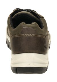 Zapato marrón con parte superior de malla texturizada, un sólido tacón de cuero, media suela blanca y suela de goma negra, con un pequeño logotipo en el lado.