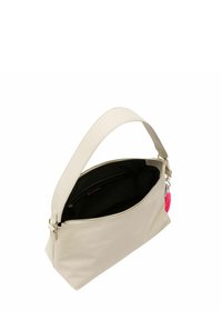 Borsa in ecopelle crema con tracolla lunga, chiusura zip, fodera interna nera e un accento in pizzo rosa. Presenta una tasca con zip all'interno.