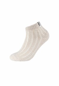 Calza alla caviglia di colore crema con texture a coste, bordo elastico e una piccola etichetta nera laterale che indica il marchio.