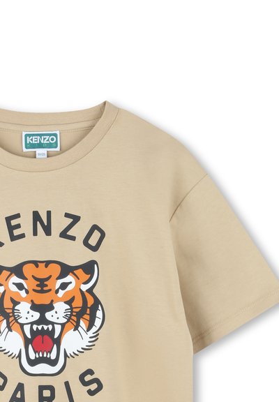 T-shirt in cotone beige con una grande grafica di una tigre nera e arancione e testo "KENZO PARIS" in grassetto nero. Design classico con collo a giro.