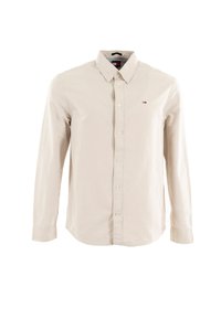 Camicia beige a maniche lunghe con colletto a punta, bottoni frontali e un piccolo logo sul petto. Tessuto di cotone morbido e vestibilità sartoriale.
