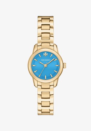 Montre-bracelet en métal doré avec un cadran bleu vif, des index dorés, et le logo ainsi que le nom Tory Burch centrés sous 12 heures.