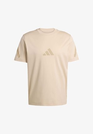 Beige katoenen T-shirt met korte mouwen, ronde hals en een subtiel ton-sur-ton logo op de borst. Voorzien van gestructureerde zijaccenten.