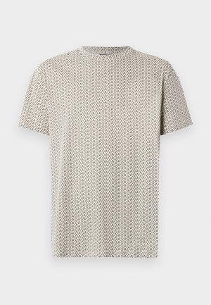 Koszulka z krótkim rękawem, okrągłym dekoltem w kolorze beżowym z czarnym wzorem w zygzaki. Wykonana z lekkiego, teksturowanego materiału.