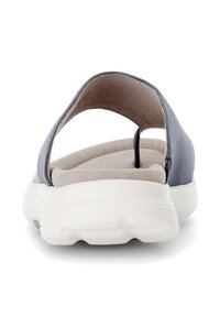 Gray sandal with a breathable upper, open back, and textured insole. Features a chunky white sole for added comfort and support.