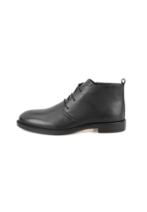 Bottines en cuir noir avec une finition lisse, bout arrondi, lacets simples et un talon bas. Se caractérise par une tirette à l'arrière.