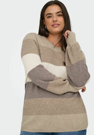 Beige og brune striper genser med V-hals, lange ermer, ribbestruktur og avslappet passform. Brukt sammen med blå denimjeans.