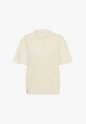 Pólóing puha krémszínű anyagból, klasszikus gallérral, rövid ujjakkal, háromgombos léccel és bordázott szegéllyel.