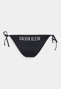Black bikini bottom with adjustable tie sides, featuring a wide waistband with the text "CALVIN KLEIN" in contrasting light grey. Smooth texture.