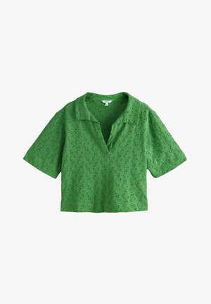 Bluza verde cu mâneci scurte, broderie floral perforată și guler deschis în V, lungime cropped și textură moale a țesăturii.