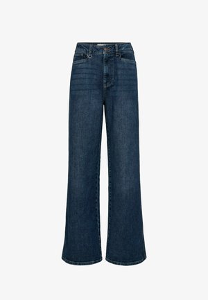 Laiade säärtega teksad tumedas sinises denimis, millel on kõrge talje, ees taskud ja peidik tõmblukk. Tekstureeritud kangas õmblustega õmbluste ääres.