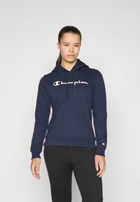 Tumesinine kapuutsiga särk, mis on valmistatud puuvillase segust, esiküljel tasku, valge "Champion" logo ja soonikvarrukad.