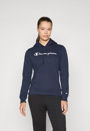 Marineblå hettegenser laget av bomullsblanding, med en frontlomme, hvit "Champion"-logo og ribbestrikkede mansjetter.