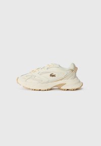Crème-kleurige sneakers met een gestructureerde bovenkant, vetersluiting en rubberen buitenzool. Heeft een subtiele logo en tan accenten op de hiel.