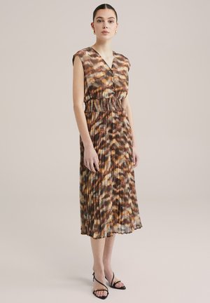 Flowy, sleeveless dress in a multicolored print of brown, orange, and cream. Waist is defined by a smocked detail, featuring a pleated skirt.