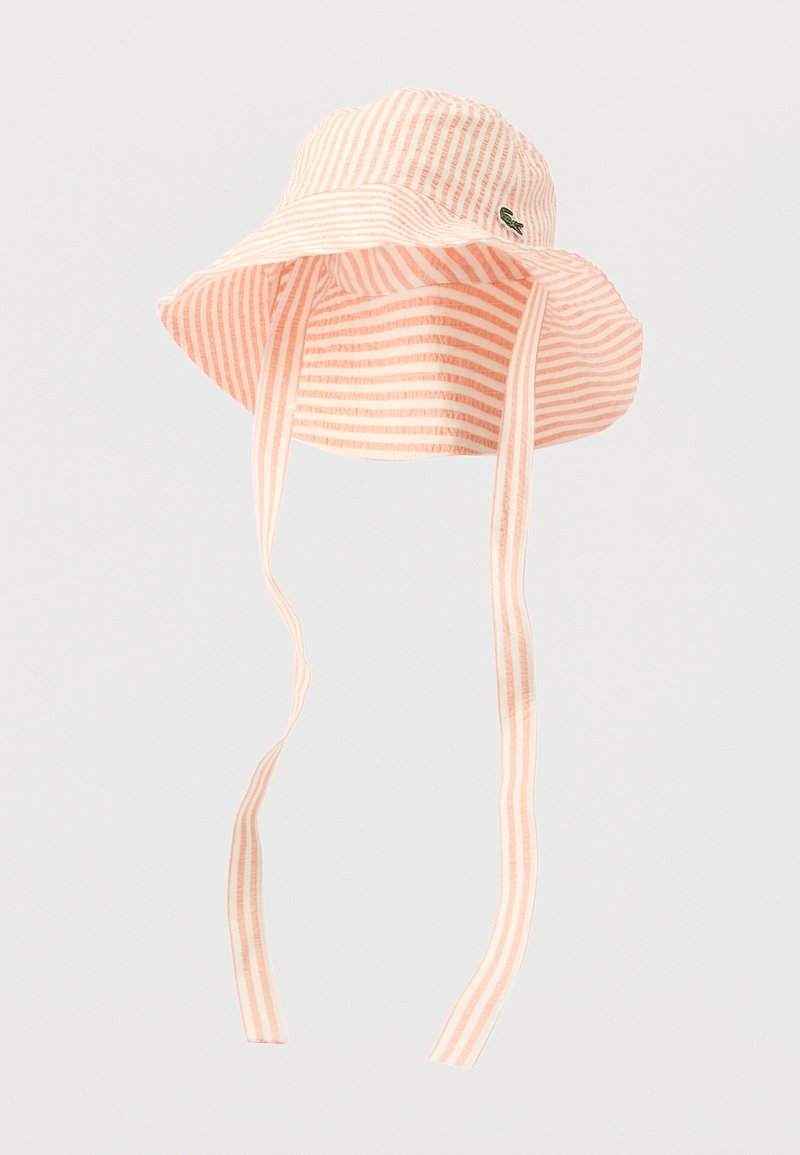 Chapeau bob rayé en rose clair et blanc, en tissu doux. Il possède un large bord et deux sangles ajustables pour un maintien sûr.