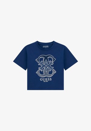 Tricou scurt bleumarin din bumbac, cu un logo grafic alb care include litere împletite și numele brandului „GUESS” fondat în 1981.