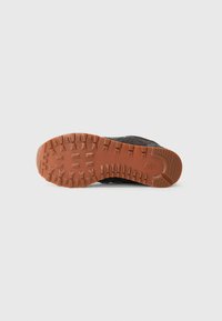Black shoe sole with a textured design and brown rubber outsole. Features deep grooves for traction and stability.